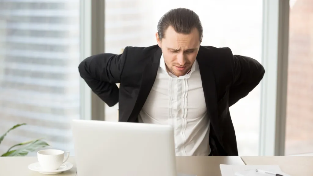 bol u leđima muškarac sjedi